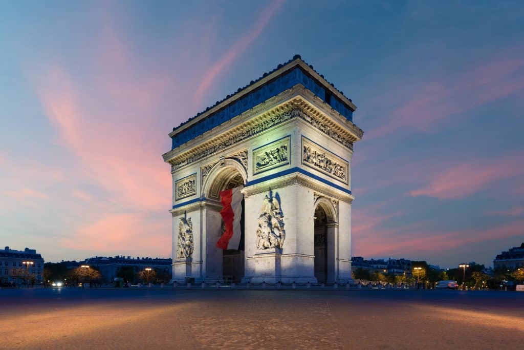 Arc de Triomphe Paris and Champs Elysees with a large France flag